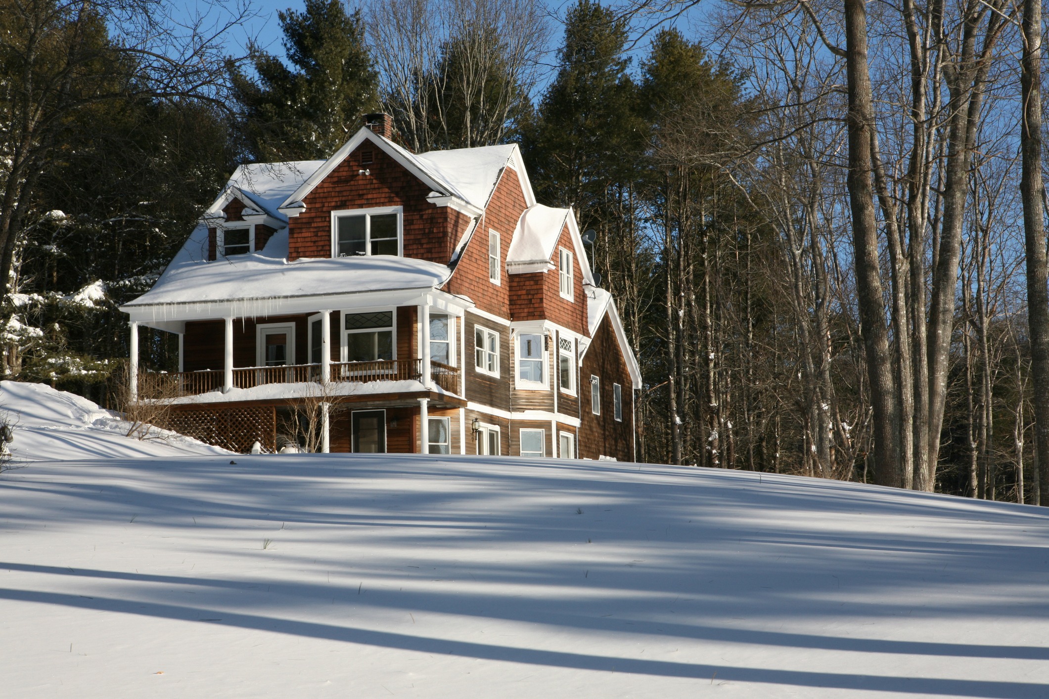 House covered in snow after a storm  on a sunny day